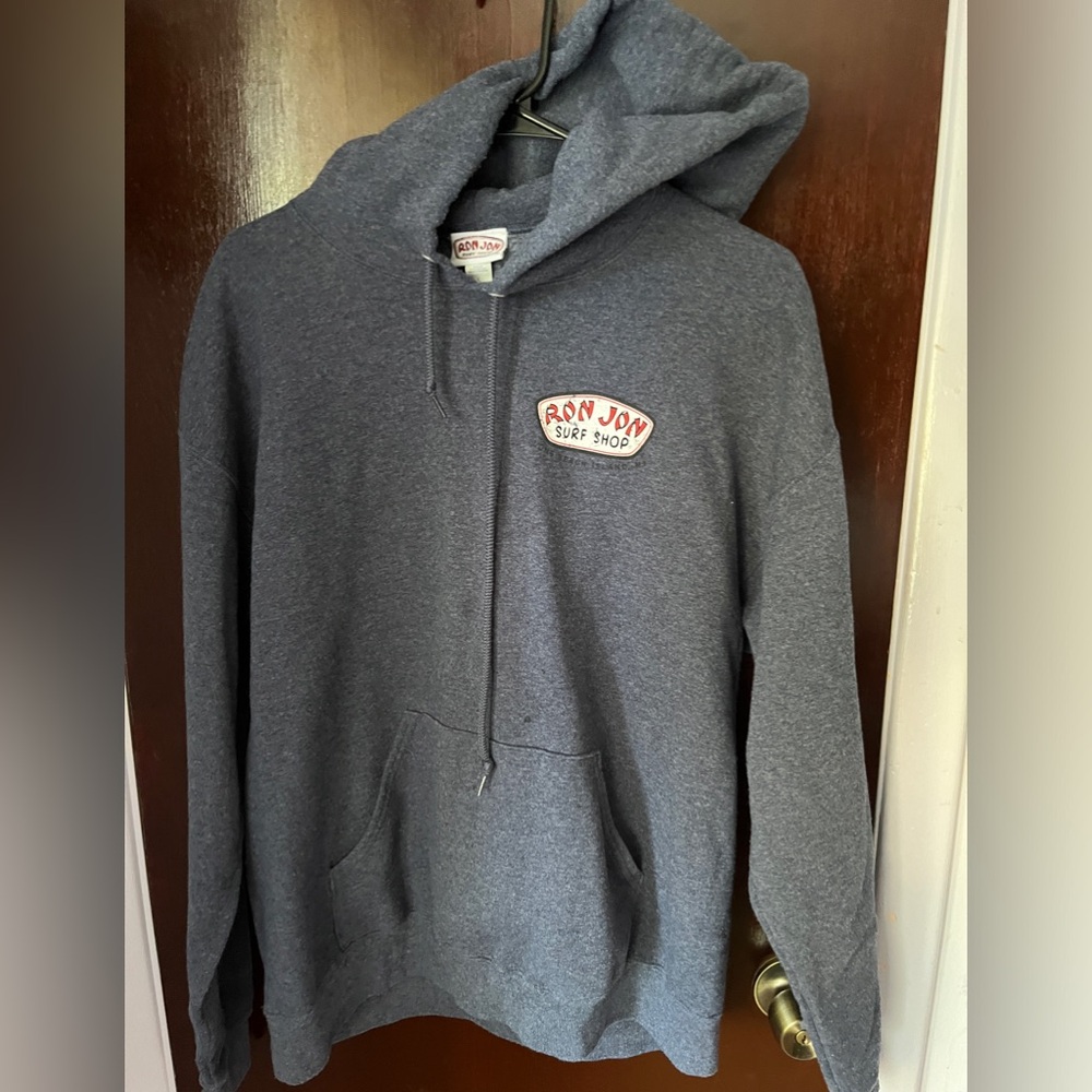 Large Ron Jon Surfboard hoodie, gray with surfboard design on back.